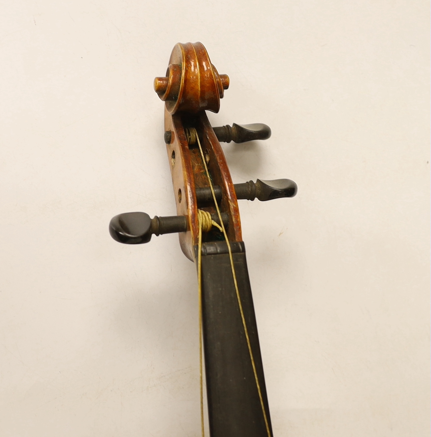 An early 20th century cased violin, length of the back 36cm